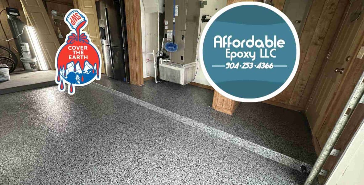 Grey flake garage floor with a lighter border beneath wood-panelled walls, with Affordable Epoxy branding.